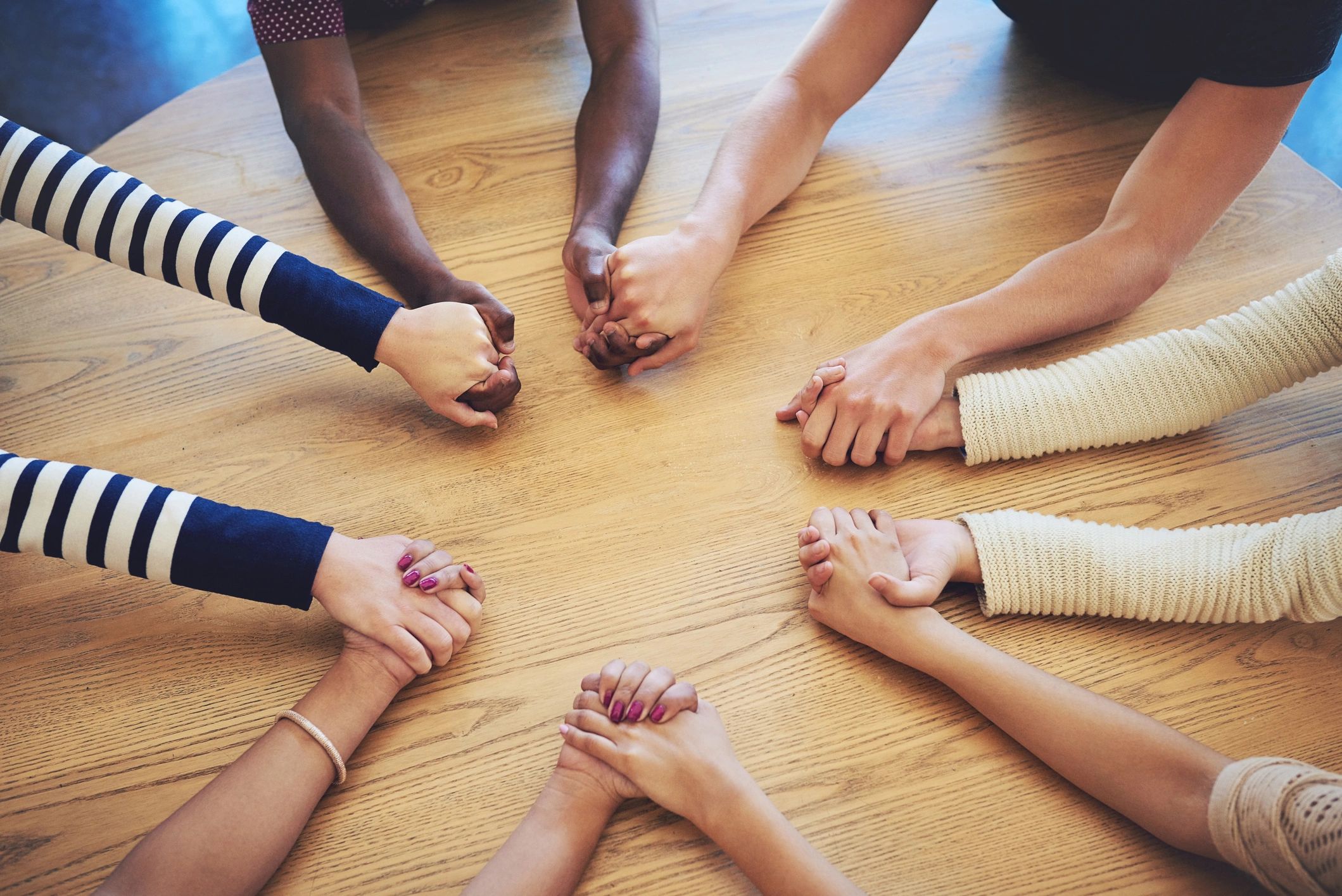 Friends joining hands in support and fellowship
